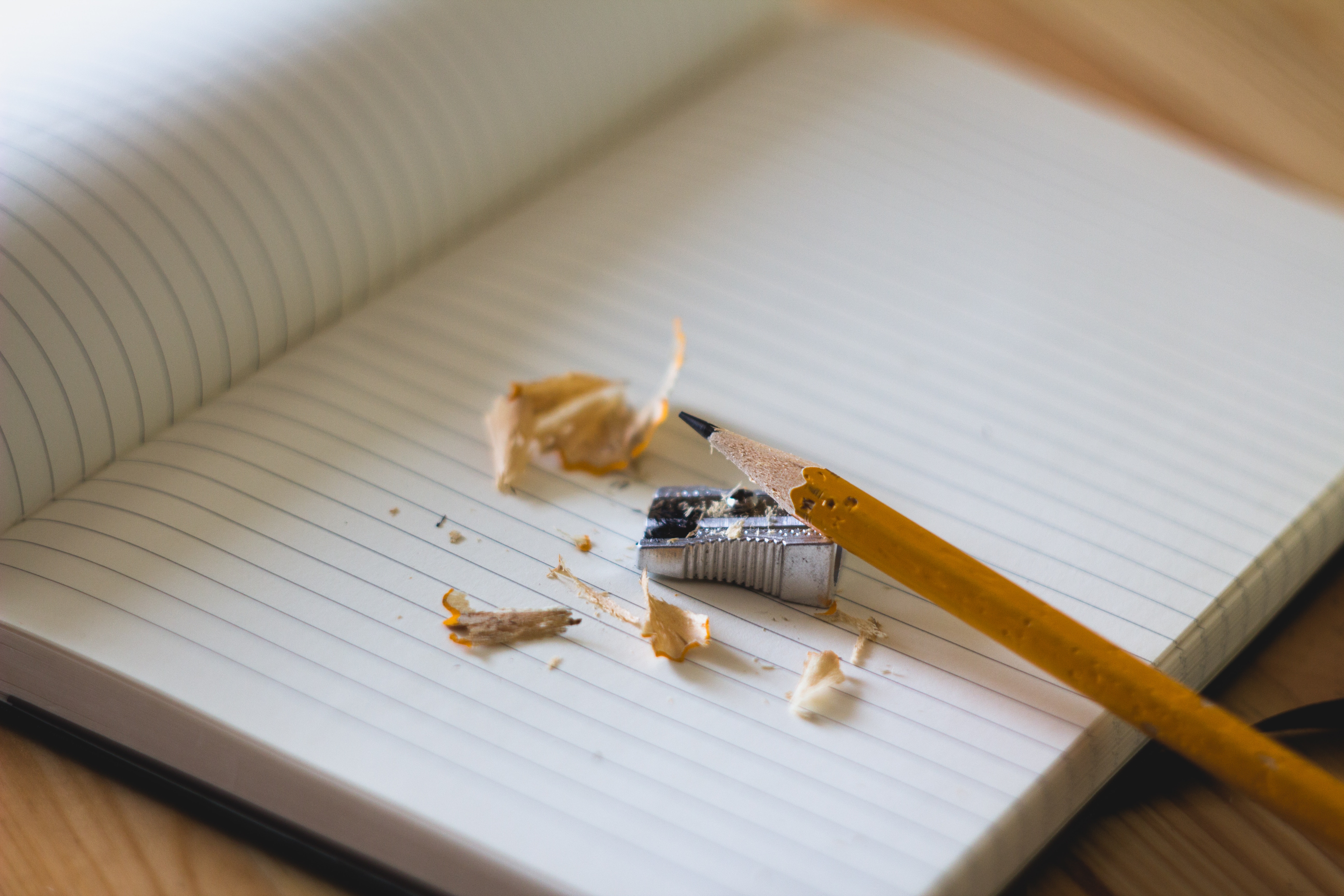 pencil with sharpener on lined notepad